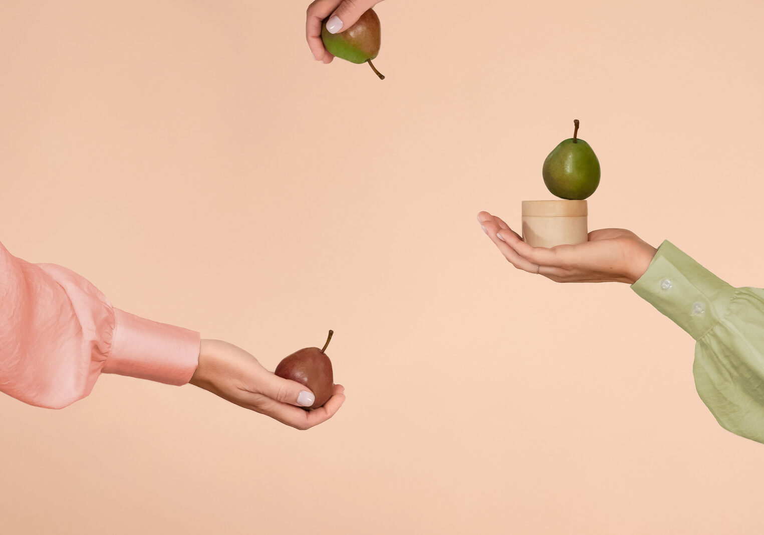Product photo with a woman model presenting pears and a jar of cosmetic cream styled by Jenni Joanna Visuals.